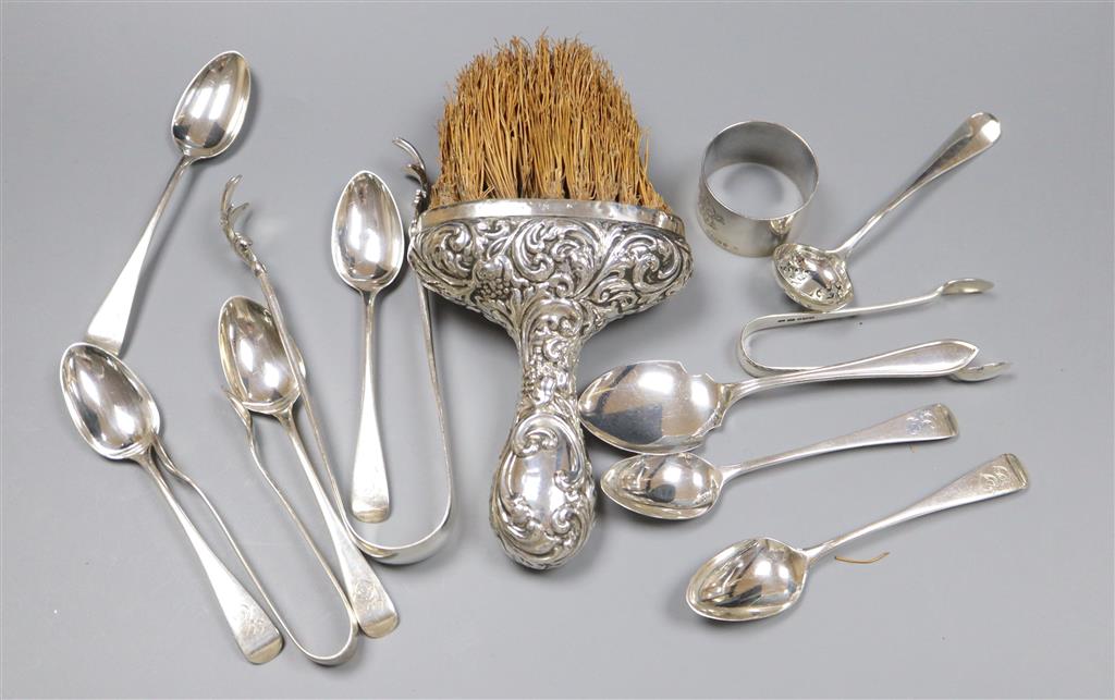 A pair of silver sugar tongs, various silver teaspoons, a sifter spoon, napkin ring and a silver-handled brush.